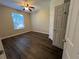 This bedroom features new floors, a ceiling fan, and a large window providing natural light at 3332 Robert Trent Jones Dr # 10703, Orlando, FL 32835