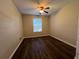 Bedroom featuring wood-look flooring, ceiling fan, and a window for natural light at 3332 Robert Trent Jones Dr # 10703, Orlando, FL 32835