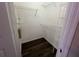 This walk-in closet offers ample storage with multiple wire shelves and dark wood-look floors at 3332 Robert Trent Jones Dr # 10703, Orlando, FL 32835