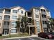 Beautiful exterior view of a multi-story condo building with stucco finish and Mediterranean-style roof tiles at 3332 Robert Trent Jones Dr # 10703, Orlando, FL 32835