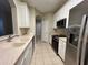 Modern kitchen featuring stainless steel appliances, white cabinets, and granite countertops at 3332 Robert Trent Jones Dr # 10703, Orlando, FL 32835