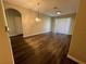 Bright living room features wood floors, neutral paint, decorative light fixture and sliding glass door at 3332 Robert Trent Jones Dr # 10703, Orlando, FL 32835