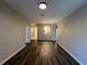 The living room showcases wood floors, neutral walls, and an arched opening to the kitchen area at 3332 Robert Trent Jones Dr # 10703, Orlando, FL 32835