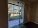 View of the outdoor patio with sliding glass doors and vertical blinds, providing a glimpse of the community at 3332 Robert Trent Jones Dr # 10703, Orlando, FL 32835