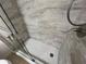 This shower features upgraded tile, a glass door, and a white hexagon tile floor at 3332 Robert Trent Jones Dr # 10703, Orlando, FL 32835