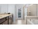 Bathroom with double vanity, granite countertops, walk-in shower, and soaking tub at 3356 Lilac Way, Davenport, FL 33897
