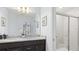Bathroom featuring a double vanity, granite counters, a large mirror, and a walk-in shower at 3356 Lilac Way, Davenport, FL 33897