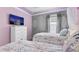 Bedroom with princess theme and decor, including two beds and a tv at 3356 Lilac Way, Davenport, FL 33897