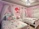 Princess themed bedroom with two beds, rose decor, and bright pink walls at 3356 Lilac Way, Davenport, FL 33897