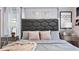 Comfortable bedroom featuring a padded headboard, two side tables, and light-colored walls at 3356 Lilac Way, Davenport, FL 33897