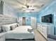 Light and airy bedroom features a wall-mounted tv, king bed, and ensuite at 3356 Lilac Way, Davenport, FL 33897