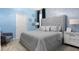Serene bedroom with a plush gray bed, soft blue walls, and tasteful decor for a relaxing atmosphere at 3356 Lilac Way, Davenport, FL 33897