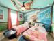 Themed ' bedroom featuring imaginative decor and comfortable twin beds, perfect for young adventurers at 3356 Lilac Way, Davenport, FL 33897