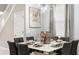 Elegant dining room featuring a modern table set for eight, a contemporary light fixture, and stylish decor at 3356 Lilac Way, Davenport, FL 33897