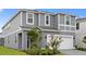 Charming gray two-story home featuring a well-maintained lawn and inviting curb appeal at 3356 Lilac Way, Davenport, FL 33897