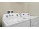 Laundry room with white washer and dryer, shelf above at 3356 Lilac Way, Davenport, FL 33897