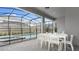 Screened in pool and spa area with a long white table and chairs at 3356 Lilac Way, Davenport, FL 33897