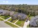 Aerial view of a beautifully landscaped home with a large backyard, mature trees, and manicured lawns at 358 Woldunn Cir, Lake Mary, FL 32746