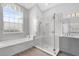 Bright bathroom showcasing a soaking tub, a glass-enclosed shower, and vanity with lots of natural light from a window at 358 Woldunn Cir, Lake Mary, FL 32746