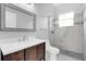 Bathroom includes a framed mirror, vanity with drawers, toilet and a tiled shower with glass doors and accent tile at 358 Woldunn Cir, Lake Mary, FL 32746