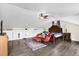 Bedroom displaying a queen bed, red furniture, wood floors, storage cubbies along the wall and a ceiling fan at 358 Woldunn Cir, Lake Mary, FL 32746