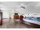 Bedroom featuring a dresser and chair, and a bed, complemented by wood floors, storage cubbies and a ceiling fan at 358 Woldunn Cir, Lake Mary, FL 32746