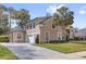 Attractive exterior elevation of a two-story stucco home with a long driveway, attached garage, and manicured lawn at 358 Woldunn Cir, Lake Mary, FL 32746