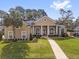 Exterior elevation of a home with a sidewalk, stucco finish, rounded windows and a nicely landscaped yard at 358 Woldunn Cir, Lake Mary, FL 32746