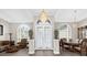 Grand foyer with high ceilings, elegant chandelier, and decorative lion statues at 358 Woldunn Cir, Lake Mary, FL 32746