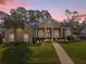 Stunning home featuring a well-manicured lawn, elegant architecture, and inviting walkway at 358 Woldunn Cir, Lake Mary, FL 32746