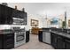 Modern kitchen with stainless steel appliances, dark cabinetry, and an open layout at 358 Woldunn Cir, Lake Mary, FL 32746