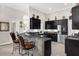 Stylish kitchen with a breakfast bar, dark cabinets, and stainless steel refrigerator at 358 Woldunn Cir, Lake Mary, FL 32746