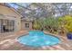 A lovely pool with a screened-in lanai surrounded by lush landscaping and plants in a backyard setting at 358 Woldunn Cir, Lake Mary, FL 32746