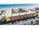 Aerial view of the beachfront condo building with a pool, manicured lawns and parking at 3801 S Atlantic Ave # 105, New Smyrna Beach, FL 32169