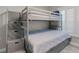 Bright bedroom features bunkbeds with built-in storage stairs and a window at 3801 S Atlantic Ave # 105, New Smyrna Beach, FL 32169