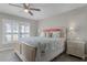Bright bedroom featuring a queen bed with a starfish theme and a window with shutter blinds at 3801 S Atlantic Ave # 105, New Smyrna Beach, FL 32169