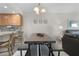 Bright dining area features a table with bench seating, pendant lighting and bar seating at 3801 S Atlantic Ave # 105, New Smyrna Beach, FL 32169