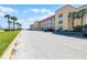 Exterior of condo building with a parking lot on a sunny day near the beach at 3801 S Atlantic Ave # 105, New Smyrna Beach, FL 32169
