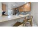 Bright kitchen featuring a breakfast bar, stainless steel appliances, and ample cabinet space at 3801 S Atlantic Ave # 105, New Smyrna Beach, FL 32169