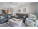 This living room features stylish seating, a ceiling fan and access to the kitchen at 3801 S Atlantic Ave # 105, New Smyrna Beach, FL 32169