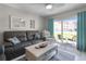 Cozy living room with comfortable seating and sliding glass doors to a patio at 3801 S Atlantic Ave # 105, New Smyrna Beach, FL 32169