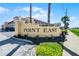 A welcoming sign 'POINT EAST' at the entrance of the community with a well-maintained landscape at 3801 S Atlantic Ave # 105, New Smyrna Beach, FL 32169