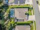 Aerial view of home featuring a private pool, solar panels, lush landscaping, and an attached two-car garage at 388 Nowell Loop, Deland, FL 32724
