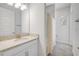 This bathroom features a large granite vanity, mirror, and shower with curtain at 388 Nowell Loop, Deland, FL 32724