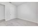 Bright bedroom featuring neutral walls and carpet with a white five panel door at 388 Nowell Loop, Deland, FL 32724