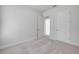 This bright bedroom features neutral walls and carpet with two five panel doors at 388 Nowell Loop, Deland, FL 32724
