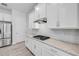 Bright kitchen featuring white cabinets, granite countertops, and stainless steel appliances at 388 Nowell Loop, Deland, FL 32724
