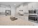 Modern kitchen features stone countertops, stainless steel appliances, white cabinetry, and a center island at 388 Nowell Loop, Deland, FL 32724