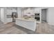 Bright kitchen with a center island features stone countertops, stainless steel appliances, and tile flooring at 388 Nowell Loop, Deland, FL 32724