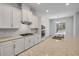 Bright kitchen featuring white cabinets, granite countertops, and stainless steel appliances at 388 Nowell Loop, Deland, FL 32724